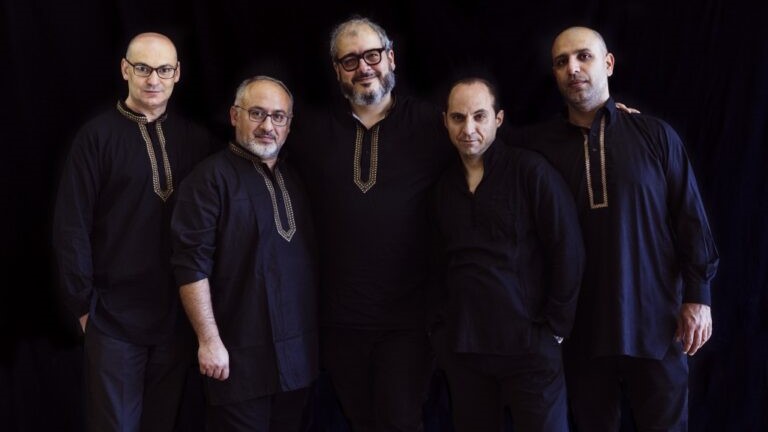 Amir Amiri Ensemble (Photo: Liliana Merizalde) Five men in dark robes face the camera.