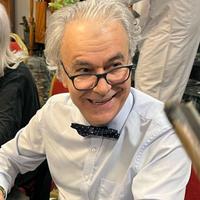 Jan Dost at the book launch of his norvel "Safe Corridor" in English. (Photo: Promo | Dar Mayara) Jan Dost wearing glasses and a bowtie, smiling at someone.